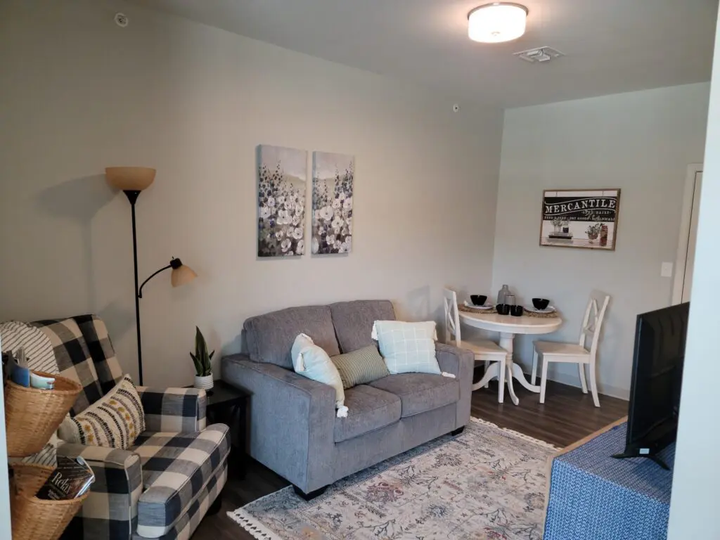 living room with couch, chair, and bistro table and chairs