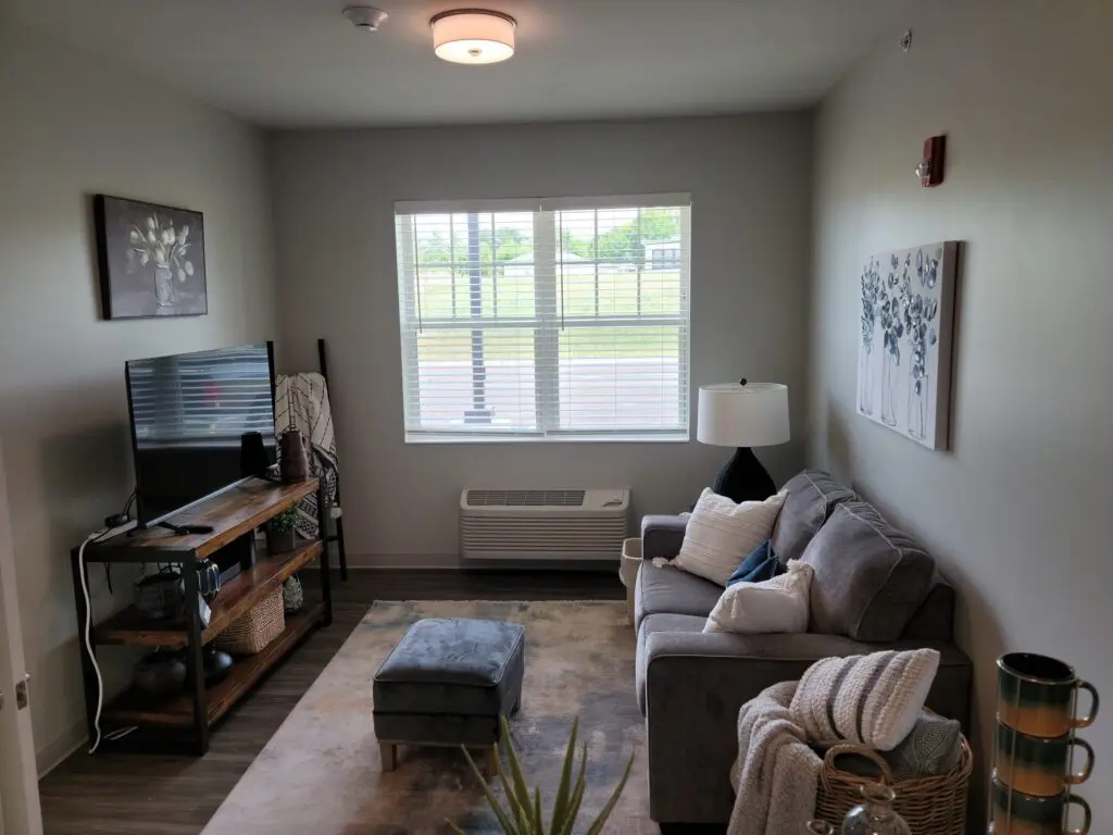 living room with tv, console, couch, and view through windows