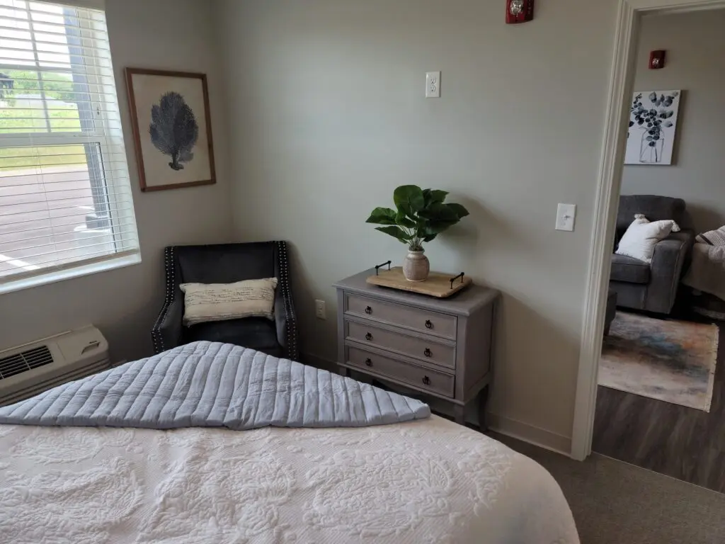 bedroom and view of living room at Charter Senior Living of Murray